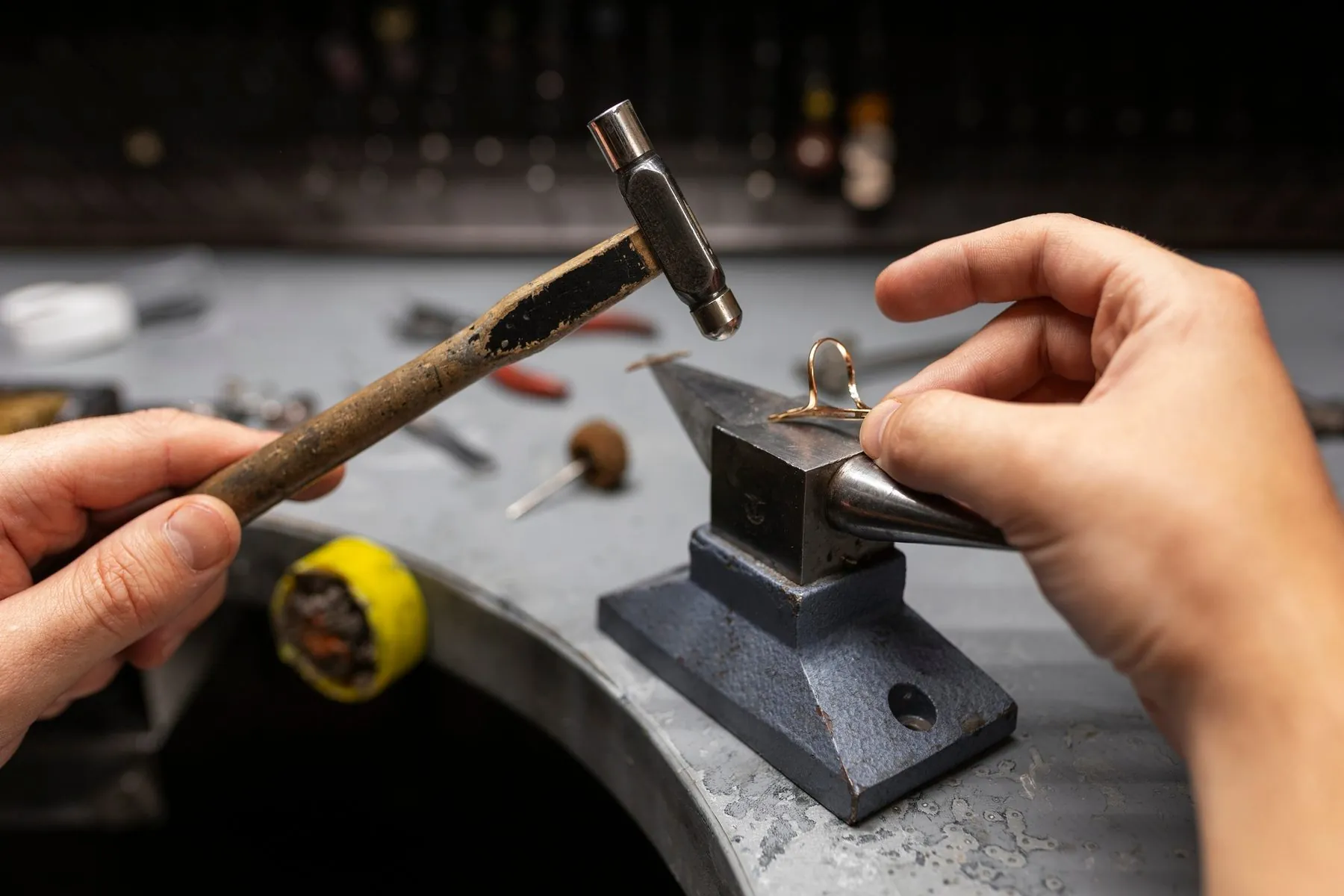 Fine hand work at the bench, where engraving is laid out and cut